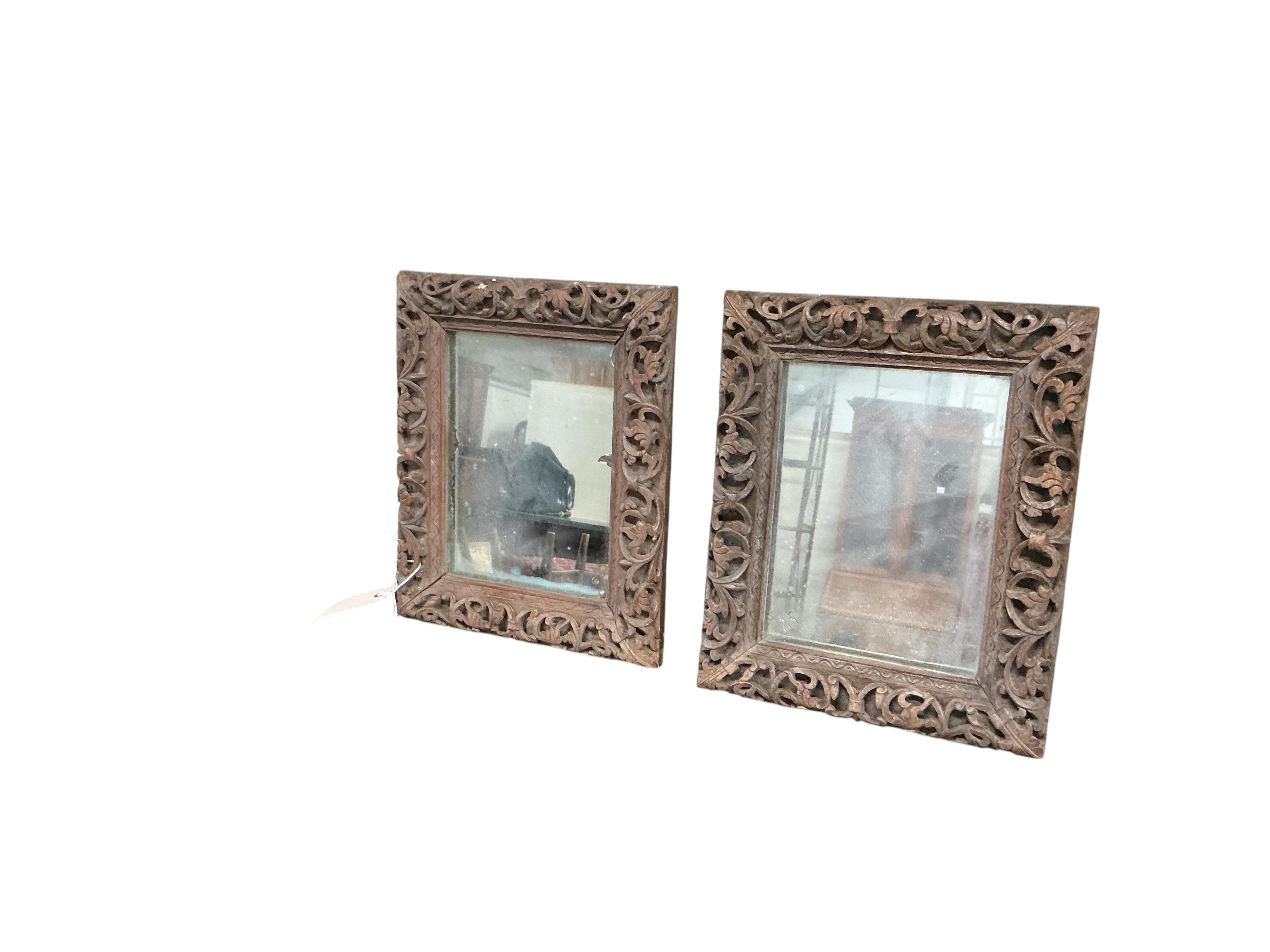 A pair of small Victorian rectangular carved oak wall mirrors, width 22cm, height 28cm